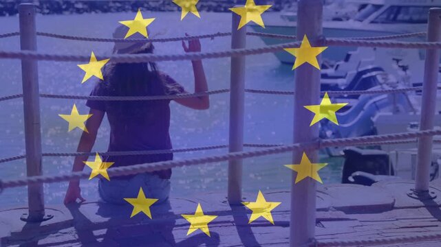 Teen sitting on dock, shading as sun glare causing hat adjusting, star overlay evoking travel