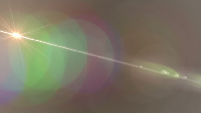 Upper-left light moving diagonally creating starburst, ghost flares and shifting bokeh testing lens