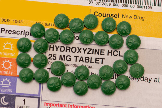 Hydroxyzine HCL pills on prescription sheet.