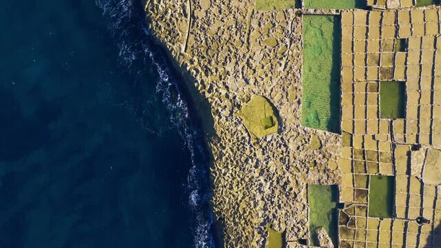 Traditional Salt Pans On The Coast Of Gozo Small Island In Malta. Aerial Topdown Shot