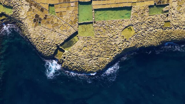 Coastal Salt Pans In Geometric Patterns On Gozo Island, Malta. Aerial Topdown Shot