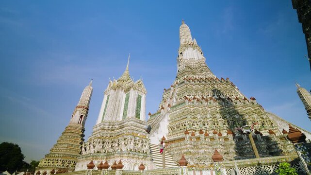 Woman In Red Dress At The Iconic Central Prang (Spire) At Wat Arun, Temple Of Dawn In Bangkok, Thailand. Low Angle Shot