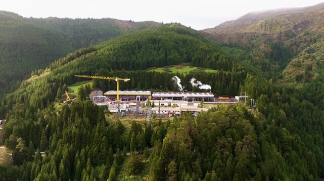 Ribeira Grande Geothermal Power Plant With Forested Mountain Background On S&atilde;o Miguel Island In The Azores, Portugal. Aerial Shot