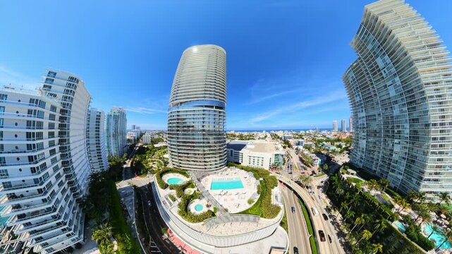 Distorted wide angle aerial video Five Park Condominium Miami Beach rising up