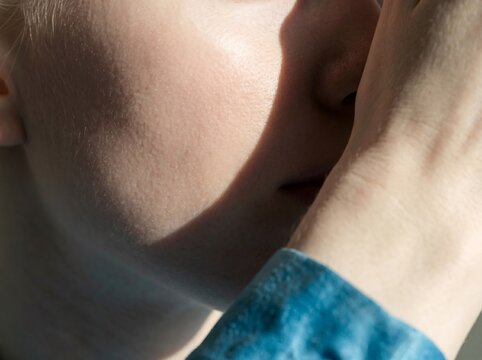 Abstract macro shot of albino woman's face and hand, skin texture and dermatology concept