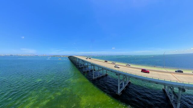 Aerial fpv video Rickenbacker Causeway Miami with boat passing under