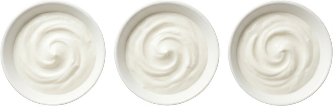 Three white ceramic bowls filled with creamy plain yogurt arranged in a horizontal row showing the smooth swirling texture of the fresh dairy product viewed from a top down overhead