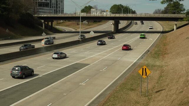 cars driving on a highway and a bridge over it, Charlotte NC