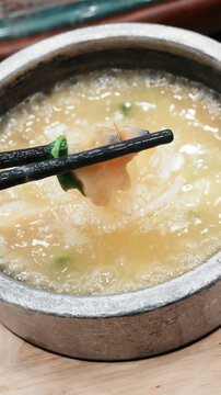 Stone Pot Conch Slice Soup (Close-Up with Chopsticks)