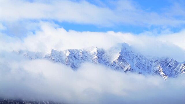 Winter The Remarkables Ski Resort snow covered peaks Time Lapse morning low cloud fog motion blue sky sun Queenstown New Zealand Southern Alps landscape Coronet Peak Kawarau Mountain Range Crown Range