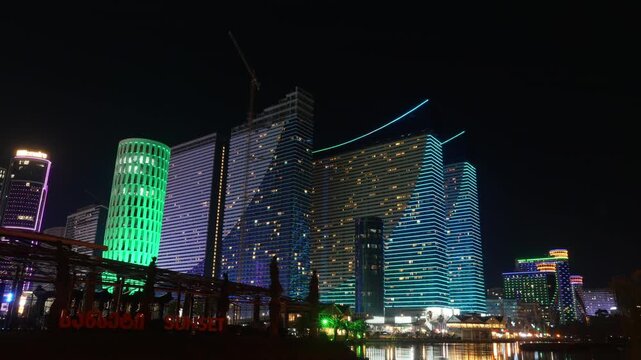 Timelapse of evening illumination of modern skyscrapers in Batumi at night. Glowing Batumi panorama with Orbi City and House of Justice. Capital of Adjara
