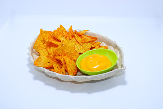Crispy Tortilla Corn Chips With Tasty Cheese Dip On White Background