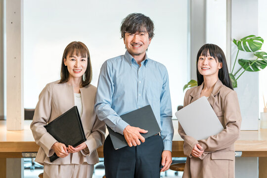Male businessmen (supervisors, executives) and their female assistants and secretaries in the company office.