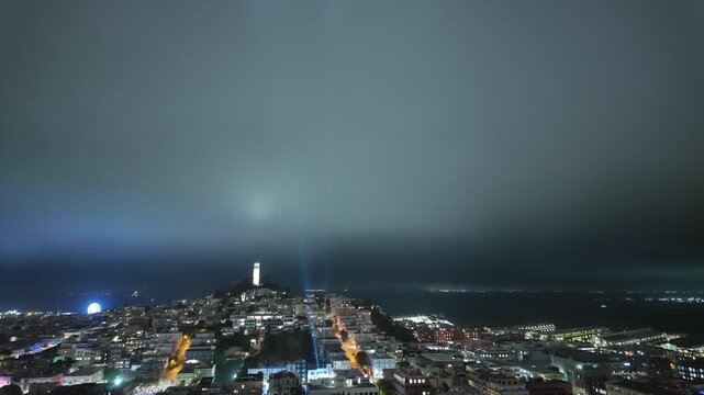 Fog rolls across North Beach in a dynamic time-lapse, partially veiling Coit Tower as traffic lights streak and the night scene evolves through layers of haze
