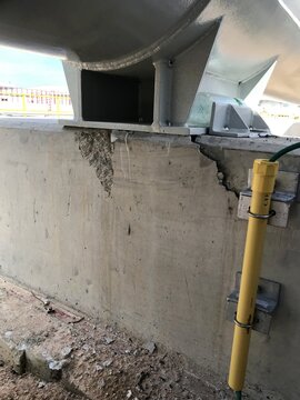Cracked Concrete Foundation With Steel Structure Base At Construction Site
