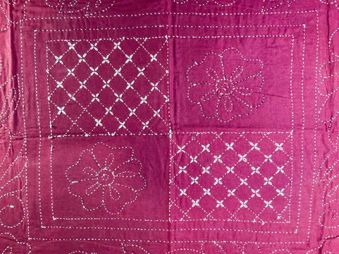 Maroon handcrafted kantha textile | white floral and checkered geometric stitch | traditional Indian folk art embroidery texture | backdrop for vintage apparel | photography