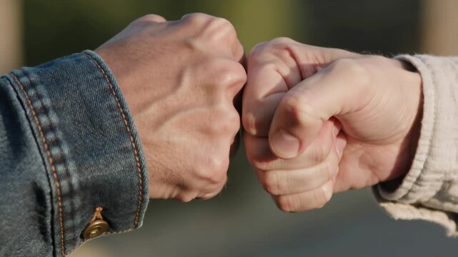 Two Men Giving A Fist Bump As A Gesture Of Teamwork And Agreement