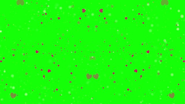 Heart shape formed with white powder on bright green background with red and white sprinkles