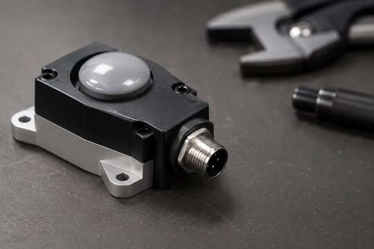 Industrial sensor module on matte workbench for commercial use