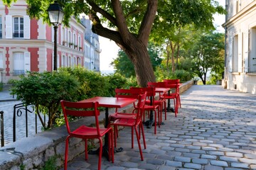 Fototapeta premium Paris Montmartre outdoor cafe with red chairs