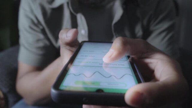 Person checking online bank account balance on smartphone
