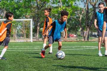 Fototapeta premium World cup concept with soccer ball or football player, youth soccer players on field in outdoor game under sunny sky