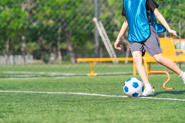 Obraz premium World cup concept with soccer or football player, soccer ball child kick field grass sport training outdoor play leg
