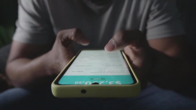 Person checking bank account balance on smartphone