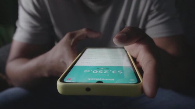 Person checking bank account balance on a smartphone