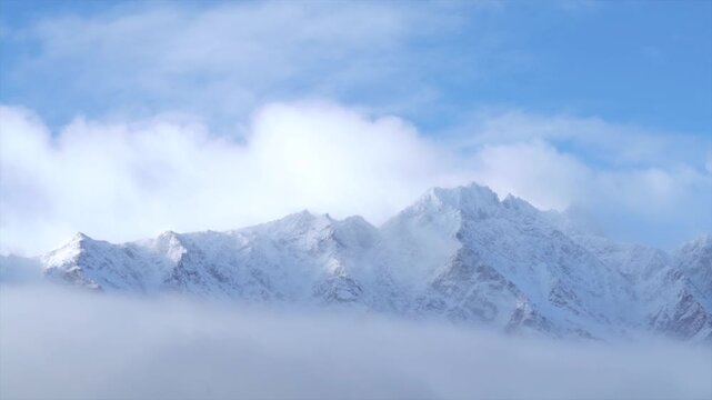 Winter The Remarkables Ski Resort snow covered peaks morning low cloud fog sunny blue sky Queenstown New Zealand South Island Glenorchy landscape Kawarau Mountain Range Crown Range Coronet Peak