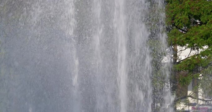 A stunning waterfall cascades down with lush surroundings capturing essence of nature's beauty.