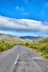 Naklejka premium Travel, empty and road with landscape for adventure, tourism destination and location in valley. Background, space and street with nature, plants and outdoor for journey, trip and route on mountain