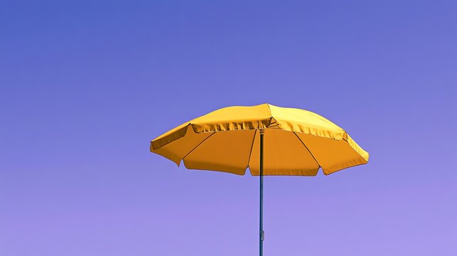 Bright yellow umbrella against a clear sky.