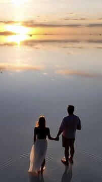 Salar de Uyuni in Bolivia during sunset. Aerial image Rainy Season.Time lapse in vertical video