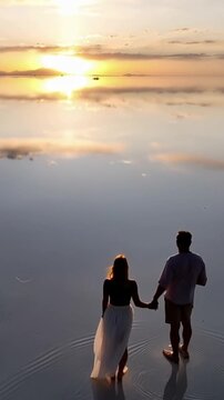 Salar de Uyuni in Bolivia during sunset. Aerial image Rainy Season.Time lapse in vertical video