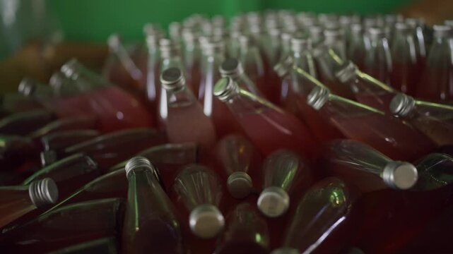Excess inventory and business failure concept: Close-up of colorful glass bottles scattered and fallen inside a warehouse, symbolizing unsold stock, financial loss, and declining business