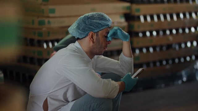 Resting Factory worker: A factory worker, burdened by the weight of labor, rests momentarily, lost in thought. A poignant image, showing the worker fatigue