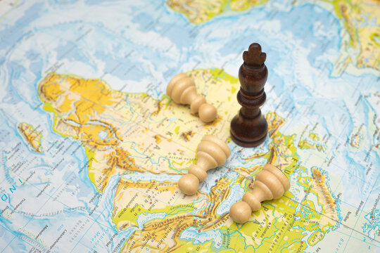 Black king chess piece standing on a map while white bishops lie fallen, symbolizing strategy, conquest, geopolitical conflict, tactical dominance and global power shifts