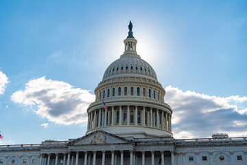 Naklejka premium Capitol dome. Historic Capitol by the national flag. Capitol dome as symbol of law. Washington monument architecture. Washington DC. US Senate. Federal government in the nation capital