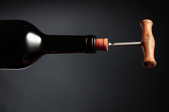 Bottle of wine and old corkscrew.