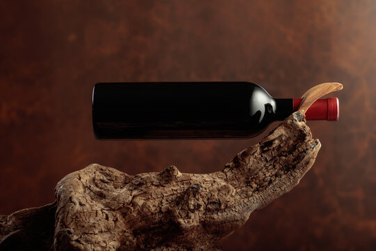 Bottle of red wine on a old wooden snag.
