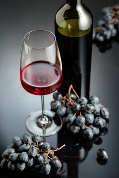 Red wine and juicy blue grapes.