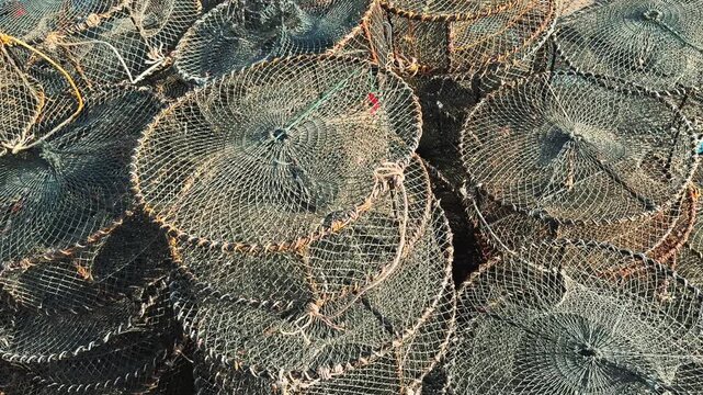 Close-Up of Vietnamese Fishing Traps and Crab Pots Stacked in Harbor 
