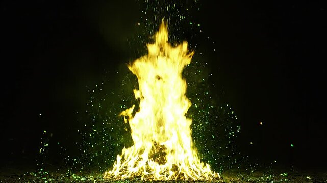 Explosion with yellow flames and green sparks against black background