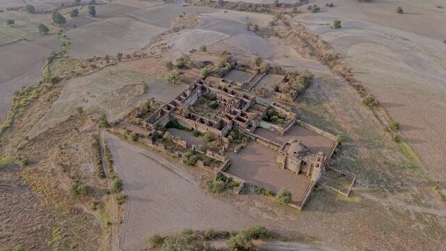 Drone flying away from caxcantla ex hacienda ruins in mexico