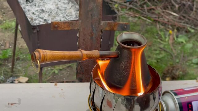 Brewing traditional Turkish coffee in a copper cezve on a camping stove.