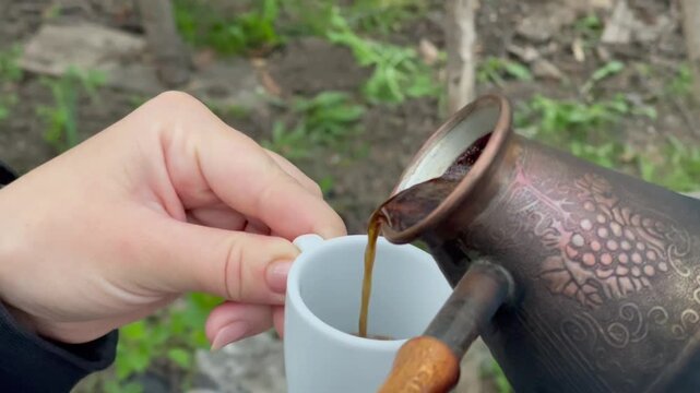 Brewing traditional Turkish coffee in a copper cezve on a camping stove.