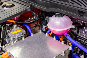 Fototapeta premium Close-up of the antifreeze tank on an electric car. Ethylene glycol in the tank on an electric car.