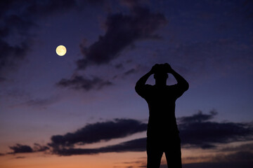 Fototapeta premium Amateur astronomer using binoculars for observing stars, planets, Moon and other celestial objects.