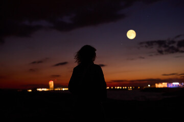 Fototapeta premium Woman observing stars, planets, Moon and other celestial objects.